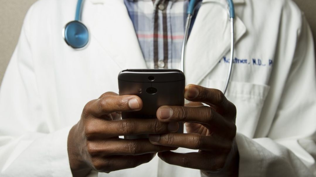 Doctor with phone in his hands